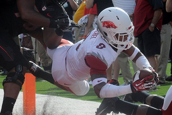 Arkansas cornerback Tevin Mithel dives into the end zone during a 27-yard interception return in the first quarter on Saturday, Sept. 21, 2013 at High Point Solutions Stadium in Piscataway, N.J. 