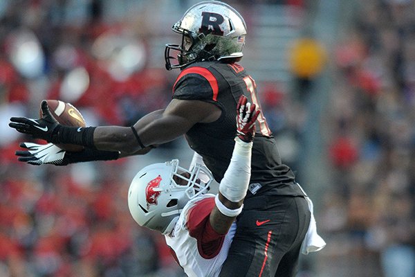 Arkansas defender Tevin Mitchel is called for pass interference as he tries to defend against Rutgers receiver Brandon Coleman in the 4th quarter of Saturday's game at High Point Solutions Stadium in Piscataway, N.J. 