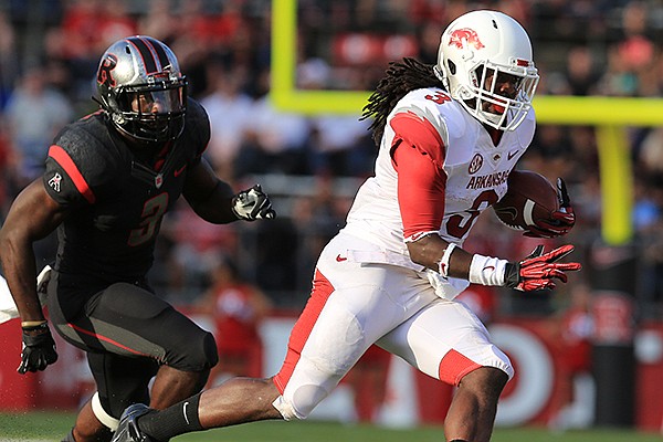 Arkansas running back Alex Collins runs away from Rutgers' Steve Longa in the 3rd quarter during their game Saturday at High Points Solutions Stadium in Pisctaway, N.J.