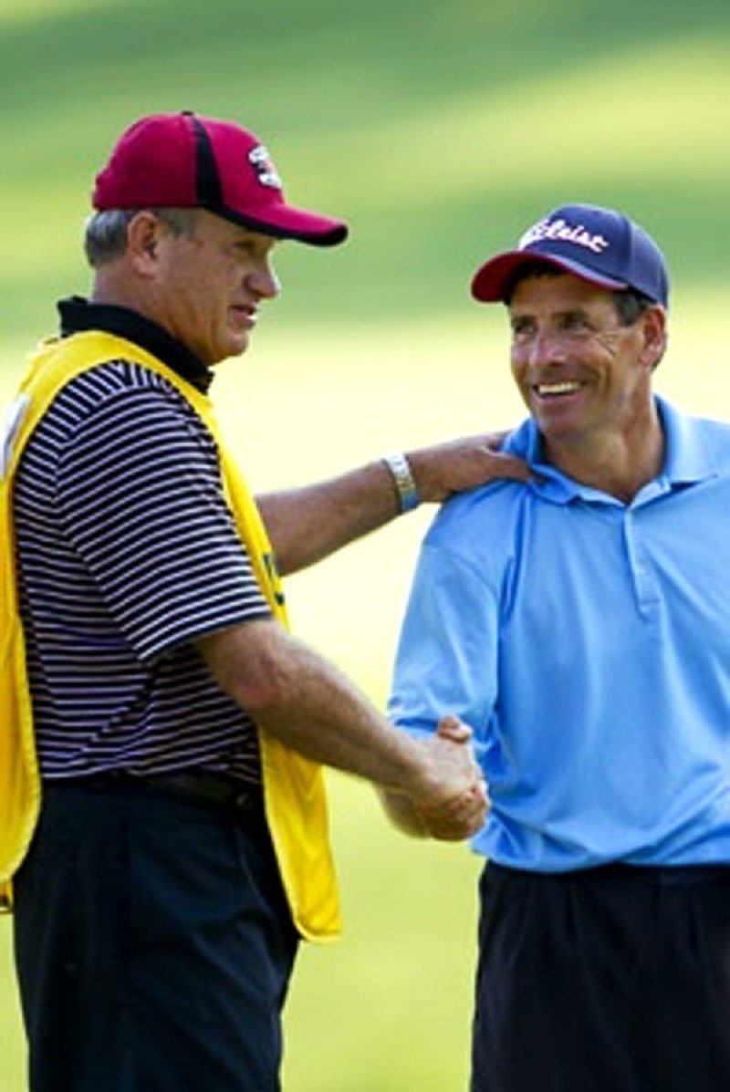 Louis Lee is embraced by his caddie/brother, Stanford Lee after his 5and4 victory at the 14th hole during the semifinal round of match play of the 2011 USGA Senior Amateur Championship at Kinloch Golf Club in Manakin-Sabot, Va., on Wednesday, September 14, 2011.