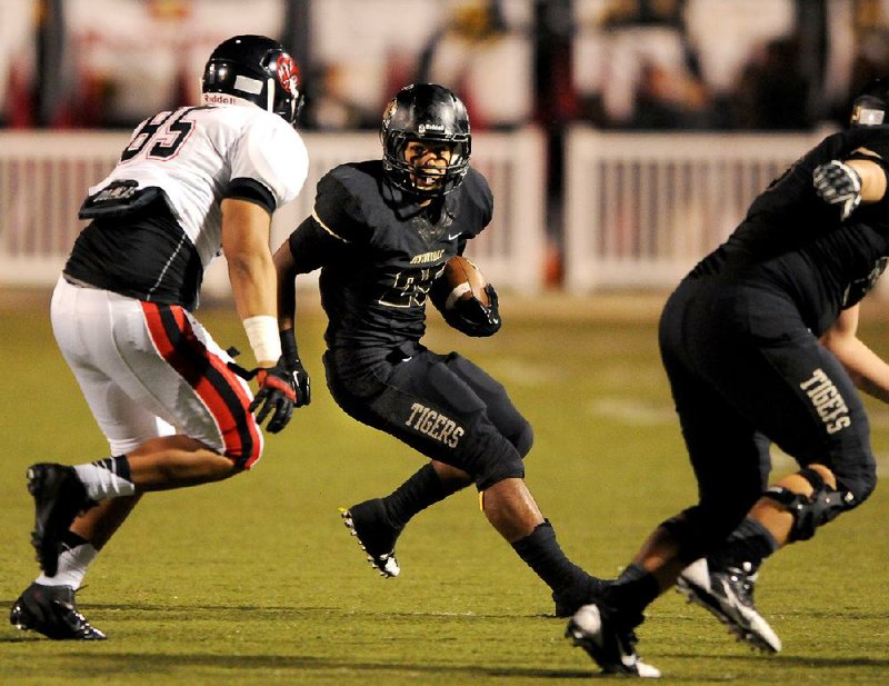 STAFF PHOTO BEN GOFF -- 09/20/13 -- Bentonville running back Dylan Smith locks his sight on a Euless (Texas) Trinity defender while carrying the ball during the football game on Friday September 20, 2013 in Tiger Stadium in Bentonville. Editors Note: Euless number 85 is not on roster. 