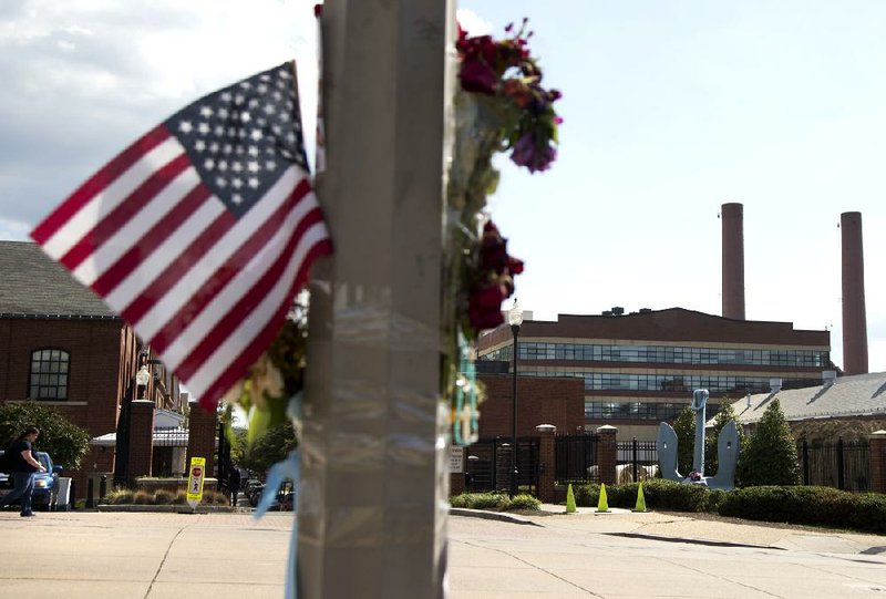 A makeshift memorial hangs on a lamppost Friday across the street from the Washington Navy Yard. 