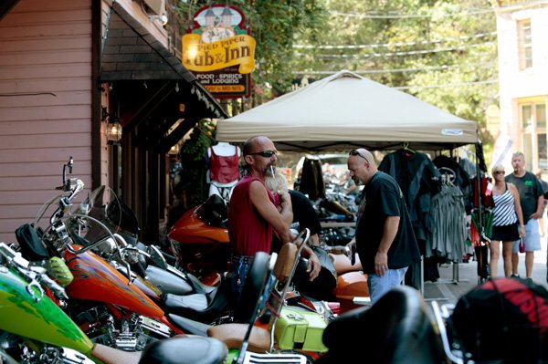 Bikers park their bikes outside of the Pied Piper Pub & Inn and the Cathouse Lounge on Thursday, Sept. 19, 2013, in downtown Eureka Springs. Many bikers are in the region for the weekend for the 14th annual Bikes, Blues and BBQ.