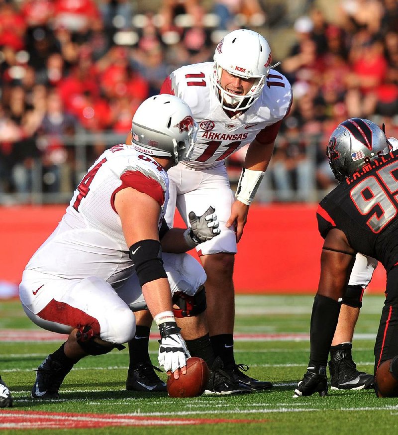 Arkansas center Travis Swanson checks with quarterback AJ Derby as Derby calls an audible. The Razorbacks are prepared to continue with Derby as the starter for next week’s SEC opener. 