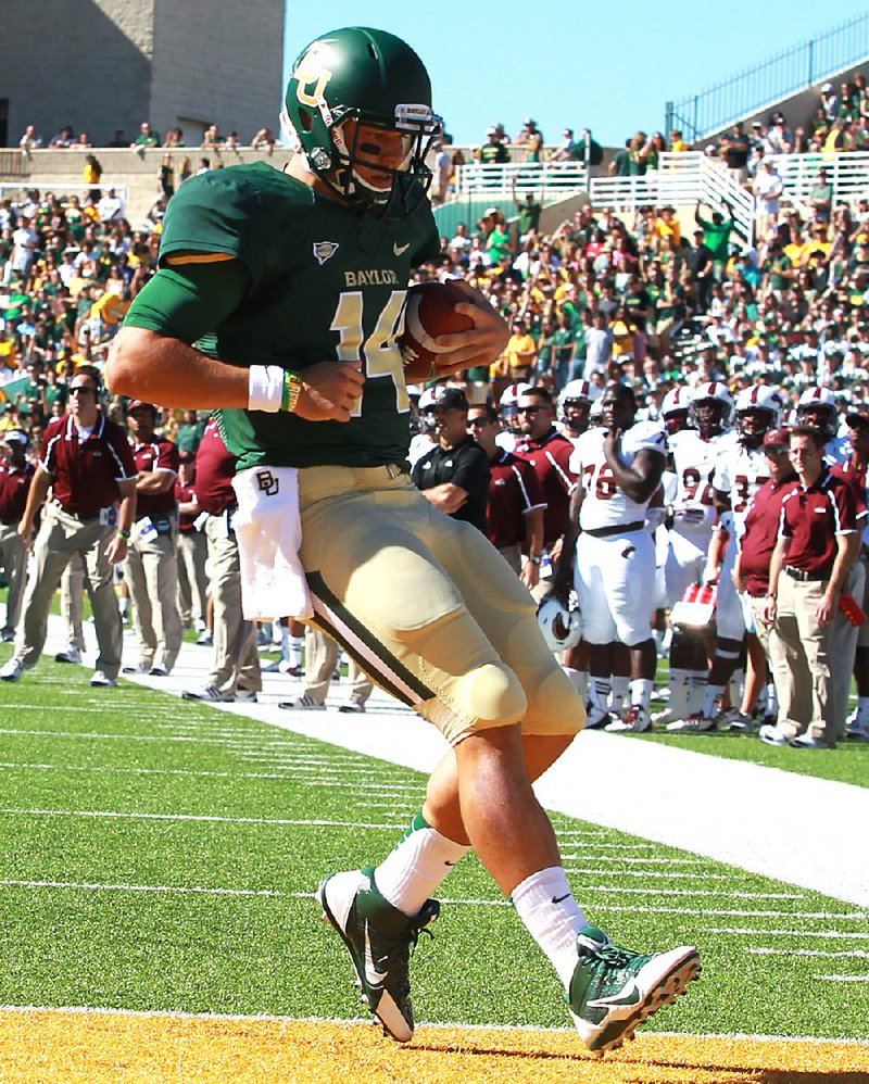 Baylor quarterback Bryce Petty (14) scores a touchdown during the first half of the No. 20 Bears’ 70-7 victory over Louisiana-Monroe on Saturday in Waco, Texas. 