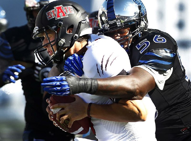 Memphis’ Terry Redden (56) sacks Arkansas State quarterback Adam Kennedy in the first half of the Tigers’ 31-7 victory in Liberty Bowl Memorial Stadium on Saturday in Memphis. 