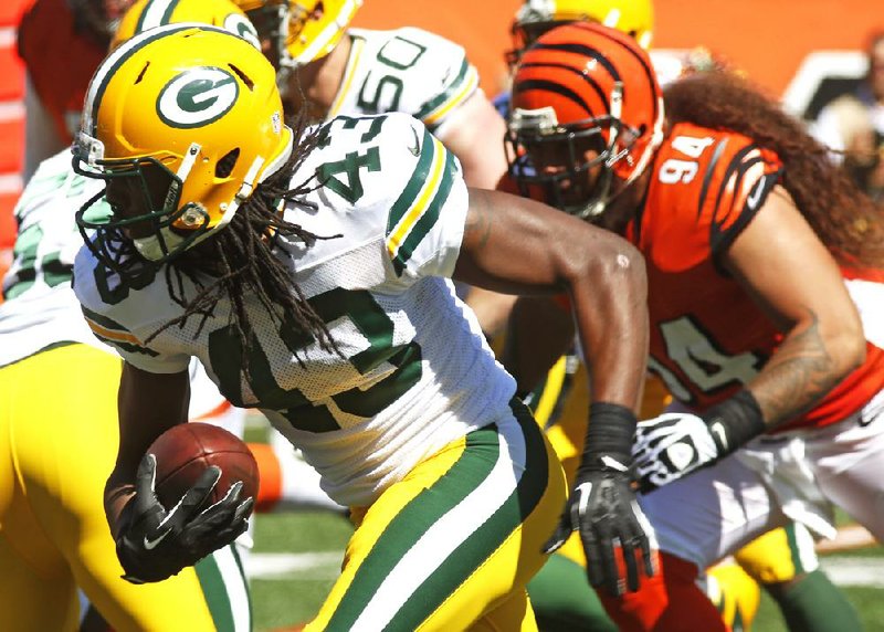 Green Bay Packers free safety M.D. Jennings (43) returns a fumble 24-yards for a touchdown in the first half of an NFL football game against the Cincinnati Bengals, Sunday, Sept. 22, 2013, in Cincinnati. (AP Photo/David Kohl)