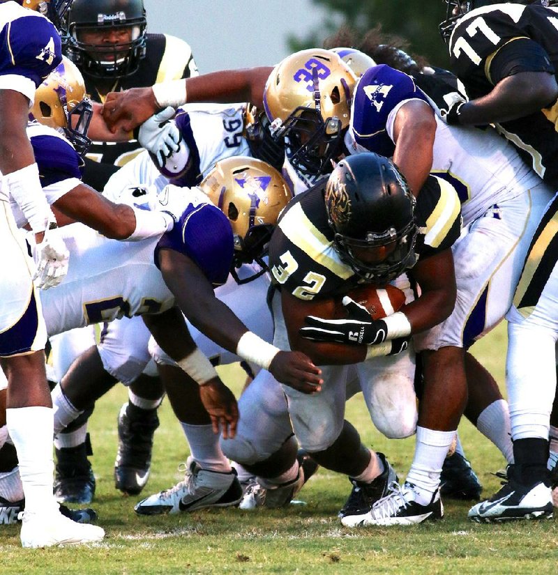 Arkansas-Pine Bluff running back Jeremiah Young is tackled by several Alcorn State defenders Saturday in Pine Bluff. 