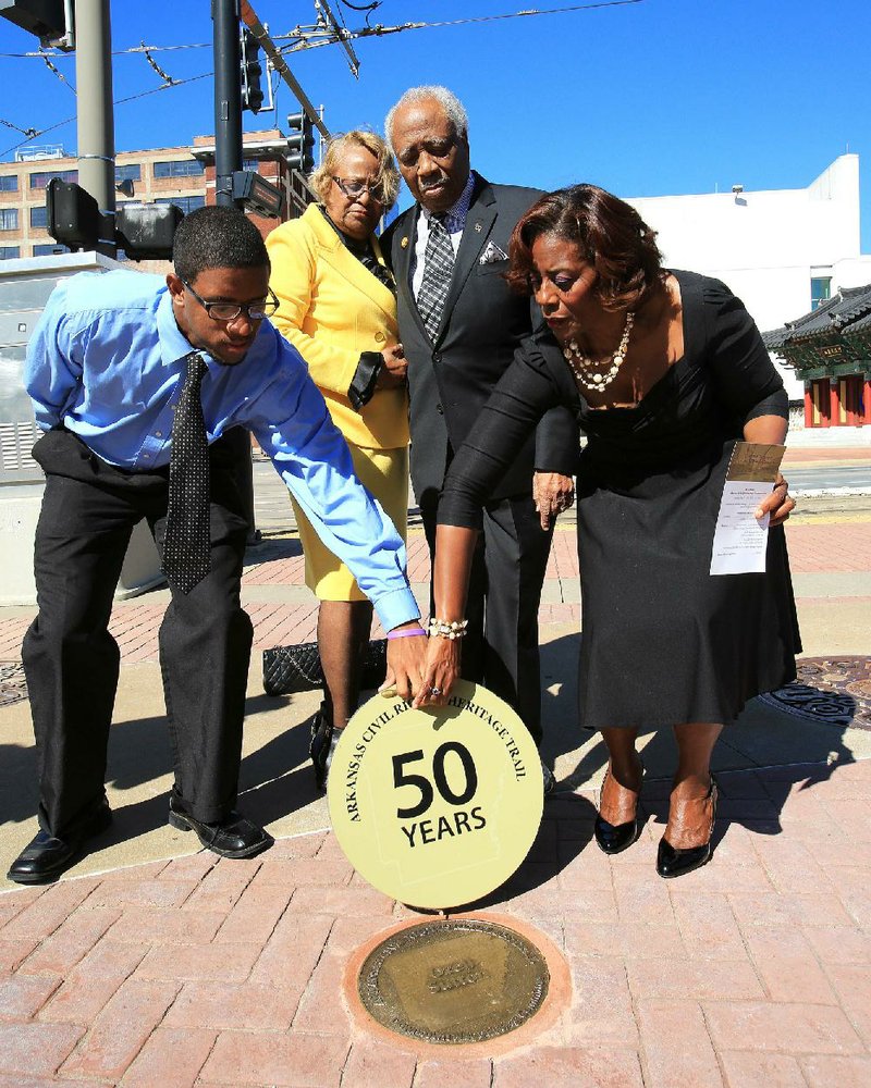  Arkansas Democrat-Gazette/STATON BREIDENTHAL --9/21/13-- Arkansas Civil Rights Heritage honoree Ozell Sutton (center right) stands with his wife, Joanna Sutton (center left) Saturday morning as his daughter, Alta Sutton (right) and Philander Smith College student Chris Davis (left) unveil  a Civil Rights Heritage marker honoring Sutton at the Little Rock Chamber of Commerce. 