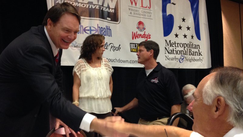 Former Arkansas coach Houston Nutt greets fans after his address of the Little Rock Touchdown Club on Monday afternoon.
