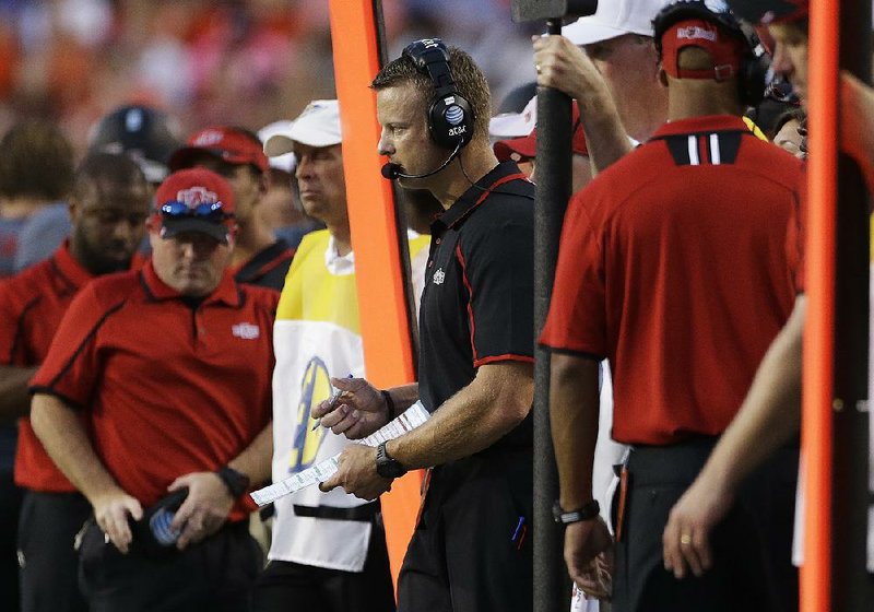 Arkansas State head coach Bryan Harsin watches from the sidelines in the first half of an NCAA college football game against Auburn in Auburn, Ala., Saturday, Sept. 7, 2013. (AP Photo/Dave Martin)