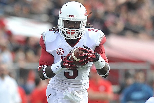 Arkansas running back Alex Collins tries to find a hole in the Rutgers defense during the Razorbacks game against the Rutgers Scarlet Knights at High Point Solutions Stadium in Piscataway, N.J. 