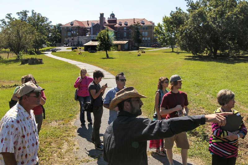 Jody Hardin (foreground) leads a tour of an organic farm planned for the 63-acre property of St. Joseph Center of Arkansas in North Little Rock. Groups on Tuesday morning met to discuss plans to repurpose the former St. Joseph Orphanage into an agricultural and education center. 