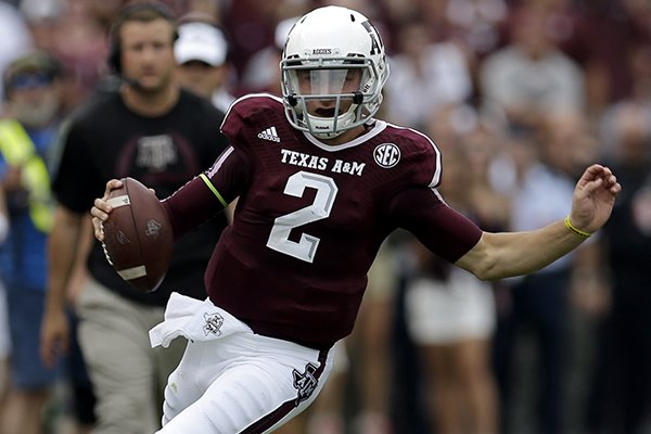 Texas A&M quarterback Johnny Manziel (2) rushes for a gain against Alabama during the first quarter of an NCAA college football game Saturday, Sept. 14, 2013 in College Station, Texas. (AP Photo/David J. Phillip)
