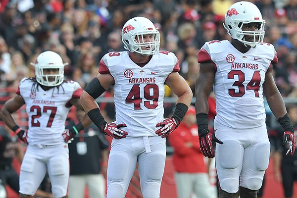 Arkansas defenders (left to right) Alan Turner, Austin Jones and Braylon Mitchell look over to the sidelines during the Razorbacks' game against the Rutgers Scarlet Knights at High Point Solutions Stadium in Piscataway, N.J. 