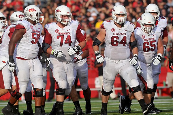 Arkansas offensive linemen (left to right) Grady Ollison, Brey Cook, Travis Swanson, Mitch Smothers and David Hurd break from the huddle during the Razorbacks' game against the Rutgers Scarlet Knights at High Point Solutions Stadium in Piscataway, N.J. 
