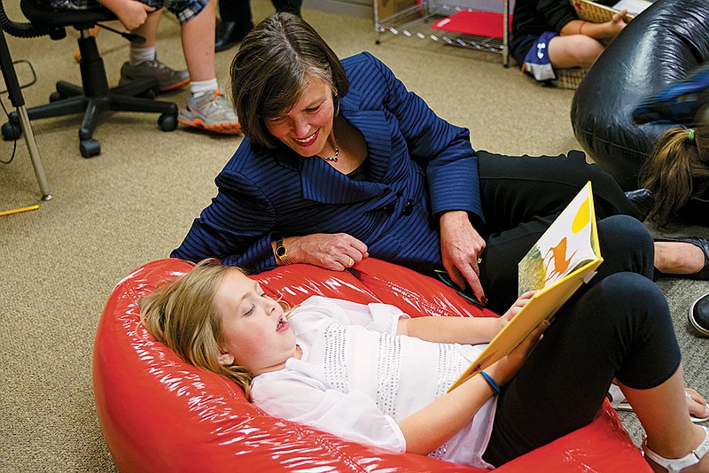 Charity Thompson, 9, reads to Kathy Spangler, vice president of U.S. Programs for Save the Children, a child-literacy and health-promotion nonprofit organization.