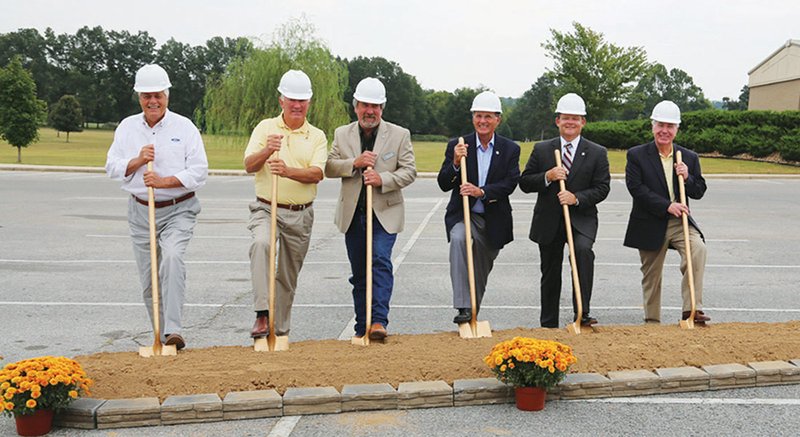 From the left, Ozarka College Board of Trustees Secretary Jack Yancey, board members Ben Cooper and Tim Gammill, Board of Trustees Chair Dennis Wiles, Ozarka College President Richard Dawe and Board of Trustees Vice Chair Bob Evins break ground on Ozarka’s new Student Services Center on Sept. 18.