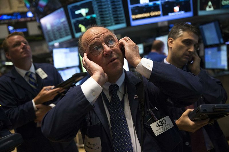 Traders work Wednesday on the floor of the New York Stock Exchange. The Dow Jones industrial average fell 61 points as concern about the economy and the possibility of a government shutdown continue to worry investors.