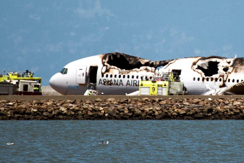 A burned Asiana Airlines Inc. Boeing Co. 777 sits on a runway at San Francisco International Airport on July 6 after a crash that resulted in three deaths and injured dozens. 