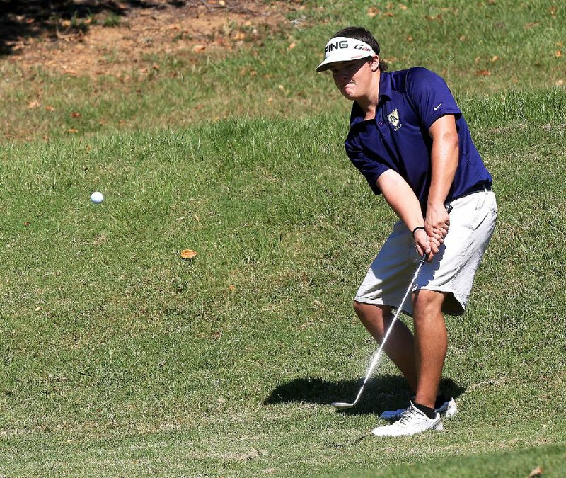 Cole Pangburn of Pulaski Academy chips onto the 11th green Wednesday during the 5A-Central golf tournament at the Greens at North Hills in Sherwood. 