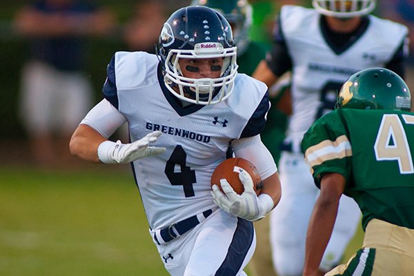 Greenwood's Hoyt Smith runs for yards during the Bulldogs' 47-7 win over Alma on Sept. 13, 2013. 