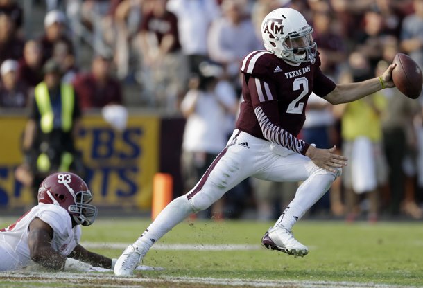 Texas A&M quarterback Johnny Manziel (2) scrambles away from Alabama linebacker Jonathan Allen (93) during the fourth quarter of an NCAA college football game Saturday, Sept. 14, 2013, in College Station, Texas. (AP Photo/David J. Phillip)