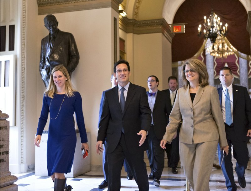 House Majority Leader Eric Cantor of Va., center, walks to the floor of the House on Capitol Hill in Washington on Friday, Sept. 27, 2013, as Congress continues to struggle over how to fund the government and prevent a possible shutdown. 