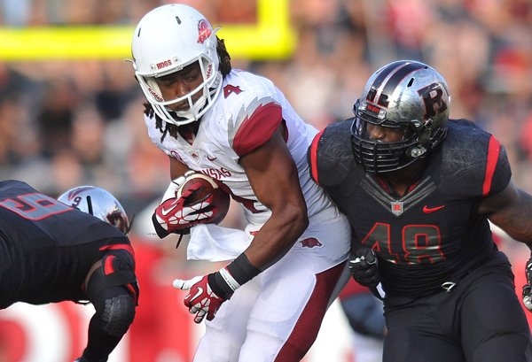 Arkansas receiver Keon Hatcher tries to shake Rutgers defenders (left to right) Tejay Johnson and Marcus Thompson against the Scarlet Knights at High Point Solutions Stadium in Piscataway , New Jersey.