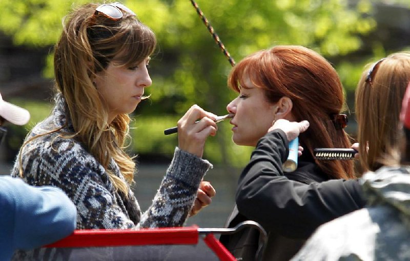 A makeup artist touches up Lauren Holly's makeup between scenes on the film set of "Hoovey" near Waxahachie, Texas, at the same house where "Places in the Heart" was filmed, Wednesday, April 24, 2013. The film is the story of Eric "Hoovey" Elliott, high school basketball player who is discovered to have a brain tumor. 