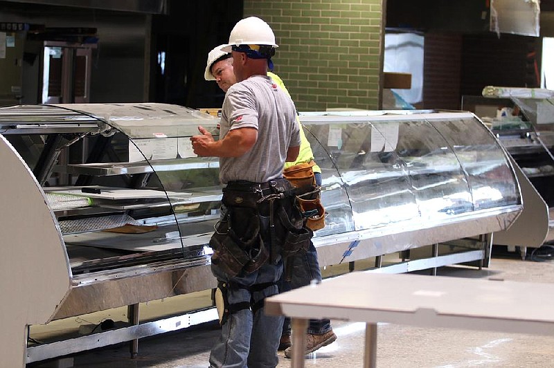 Workers last week install counters inside a new Whole Foods Market being built in Park Ridge, Ill. The grocery chain is expected to open 11 new stores in the U.S. by fall 2014. 