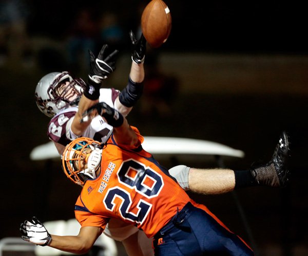 Rogers Heritage junior Joey Saucier breaks up a pass in the end zone intended for Siloam Springs junior Parker Baldwin during the first half on Friday, Sept. 27, 2013, at Gates Stadium in Rogers.