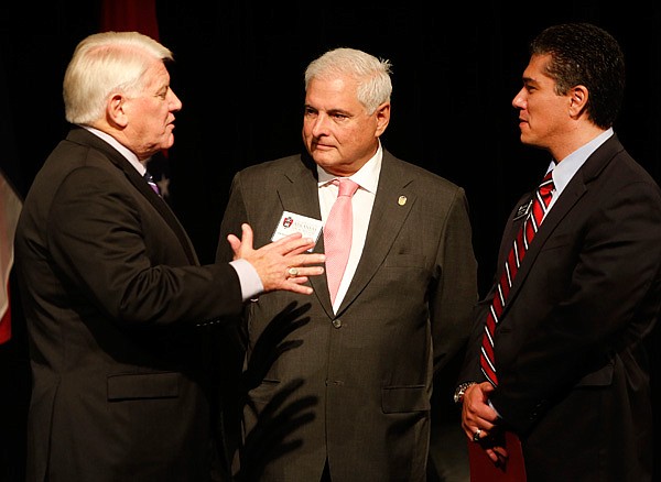 Fayetteville Chamber of Commerce President and CEO Steve Clark (left to right) speaks with Panama President Ricardo Martinelli and University of Arkansas vice provost for distance education Javier Reyes after Martinelli spoke to an audience Friday morning Sept. 27, 2013 at the University of Arkansas Global Campus in Fayetteville. Martinelli was part of opening activities for the inaugural Northwest Arkansas Hispanic Heritage Festival and Health Fair taking place Friday and today at the Washington County Fairgrounds.