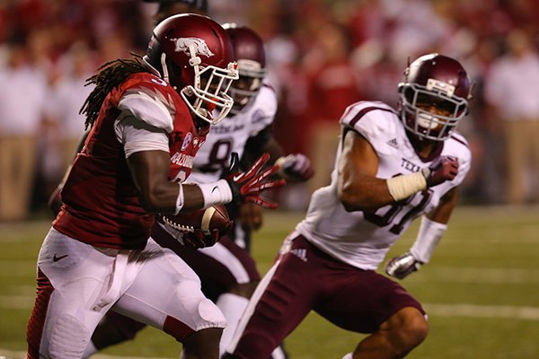 Arkansas running back Alex Collins runs during the first half of Saturday's game against Texas A&M at Razorback Stadium in Fayetteville. 