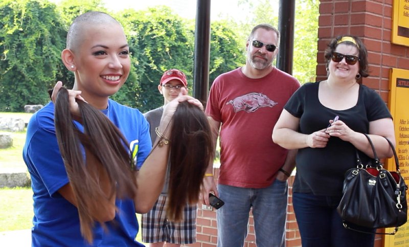 Southern Arkansas University student and Phi Mu sorority member Marissa Aranda, 20, grins after shaving her hair on Saturday, Sept. 28, 2013. Aranda, who raised approximately $10,000 to donate to the Children's Miracle Network, said she wanted to shave her hair to raise awareness about childhood cancer. 