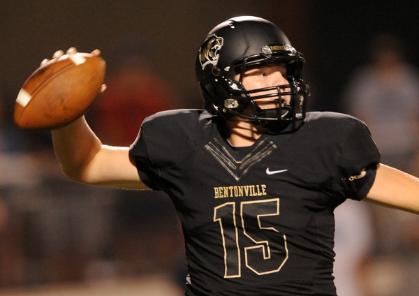 Bentonville quarterback Kasey Ford throws a pass during the first half of the game against Springdale Har-Ber in Tiger Stadium on Friday September 27, 2013.