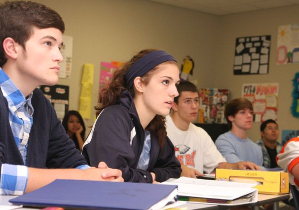 Seniors Brady Precure and Sara Jo Archer listen during a discussion on psychological defense mechanisms in Lea Ann Moss' Advanced Placement Psychology class. Student enrollment in Advanced Placement classes has doubled in the Rogers School District since 2008.