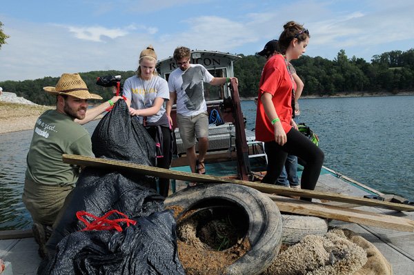 LAKE CLEANUP CREW
Beaver Lake Cleanup volunteers, from left, Chris Marston, Jackquelyn Francis, Marrick O'Quin, Brad Hampson and Destinee Swearengin unload shoreline trash they picked up on Saturday Sept. 28 2013 during the annual litter-removal event. Volunteers picked up debris along the shore then were treated to lunch and prize drawings at Prairie Creek park.