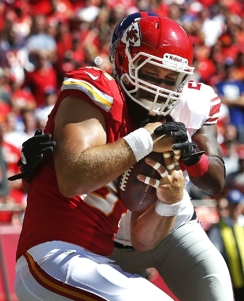 Kansas City Chiefs tight end Sean McGrath, front, makes a touchdown catch while covered by New York Giants strong safety Antrel Rolle during the first half of an NFL football game at Arrowhead Stadium in Kansas City, Mo., Sunday, Sept. 29, 2013. (AP Photo/Ed Zurga)