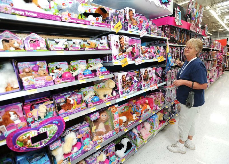NWA Media/ANDY SHUPE - Patricia Sisemore, sales associate for Walmart Stores, Inc., shows one of several toy aisles of toys Tuesday, Sept. 24, 2013, in the Walmart Supercenter on Mall Avenue in Fayetteville.