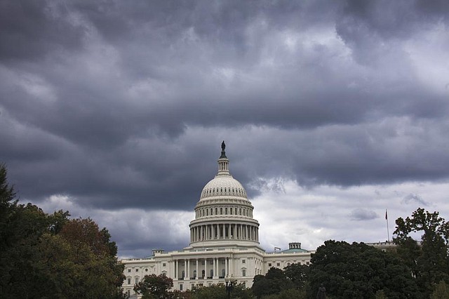 Dark clouds hang over the U.S. Capitol on Saturday where the House of Representatives debated a plan to try to delay President Barack Obama’s health-care law for a year. 