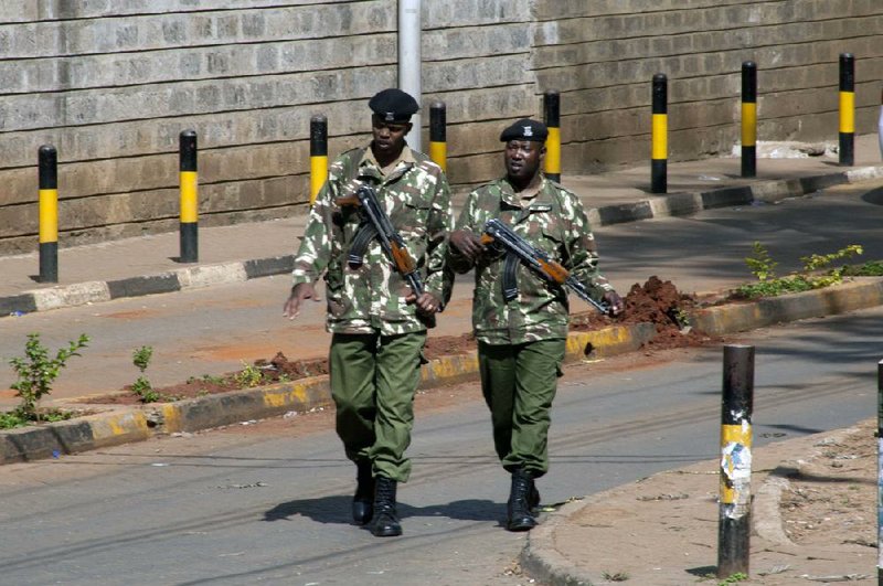 Kenyan security personnel patrol near the Westgate Mall after it was reopened, in Nairobi, Kenya, Saturday, Sept. 28, 2013. Almost a week after 67 people were killed in a attack on the upscale shopping center, there is still no clear word on the fate of dozens who have been reported missing and no details on the terrorists who carried it out. (AP Photo/Sayyid Azim)