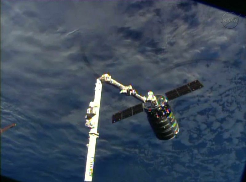 This framegrabbed image provided by NASA-TV shows the Cygnus spacecraft attached to the Canadarm 2 on the International Space Station Sunday Sept. 29, 2013. At the time both vehicles were travelling over the Indian Ocean. (AP Photo/NASA-TV)