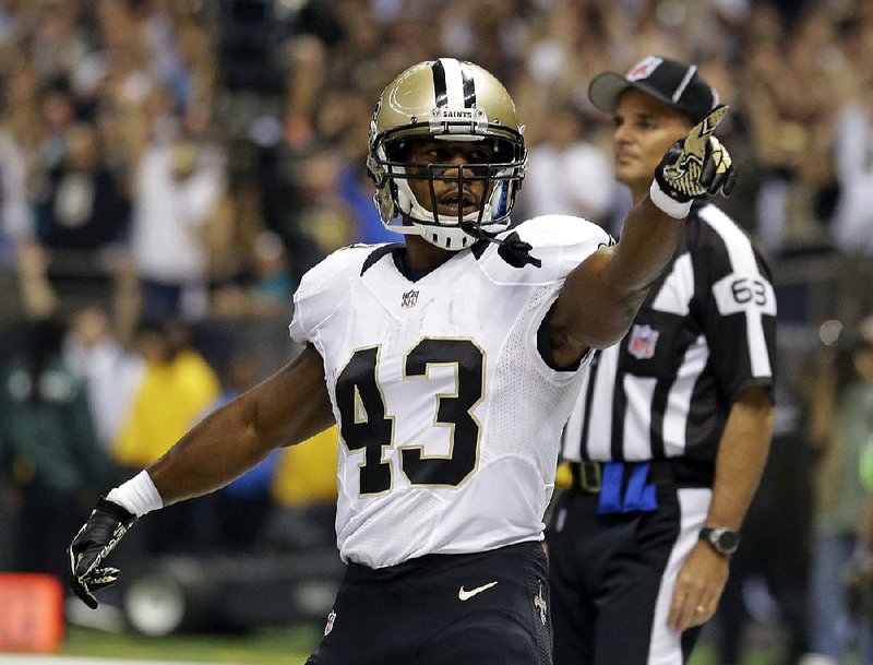 New Orleans Saints running back Darren Sproles points to fans after scoring on a touchdown carry in the first half of an NFL football game against the Miami Dolphins in New Orleans, Monday, Sept. 30, 2013. (AP Photo/Gerald Herbert)