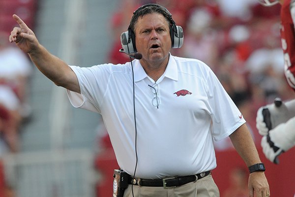 Arkansas offensive line coach Sam Pittman instructs his players during an Aug. 31, 2013 game against Louisiana-Lafayette at Razorback Stadium in Fayetteville. 
