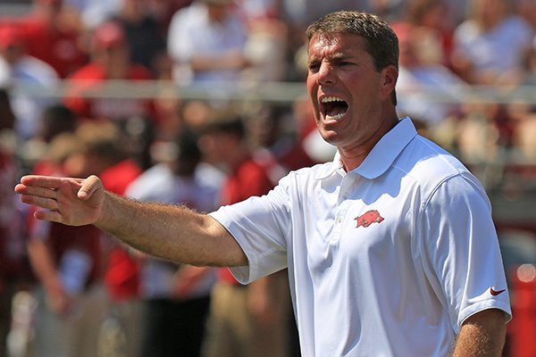 Arkansas defensive coordinator Chris Ash instructs players prior to an Aug. 31, 2013 game against Louisiana-Lafayette at Razorback Stadium in Fayetteville. 