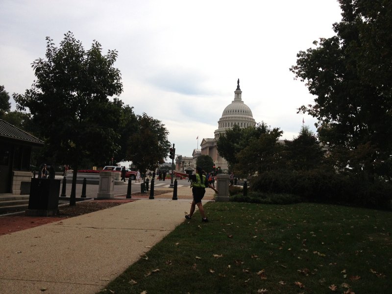 A police officer walks near the Capitol after a shootout that occurred on Thursday, Oct. 3, 2013. 