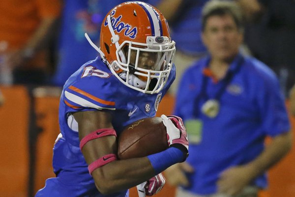 Florida defensive back Loucheiz Purifoy (15) runs for a 42-yard touchdown after intercepting an Arkansas pass during the first half of an NCAA college football game in Gainesville, Fla., Saturday, Oct. 5, 2013.(AP Photo/John Raoux)