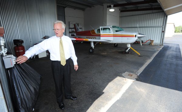 Pat Ross of Fort Smith, owner of Ross Executive Aviation Inc., shows the interior of a T-hangar that he rents Friday, Oct. 4, 2013, at Drake Field in Fayetteville.