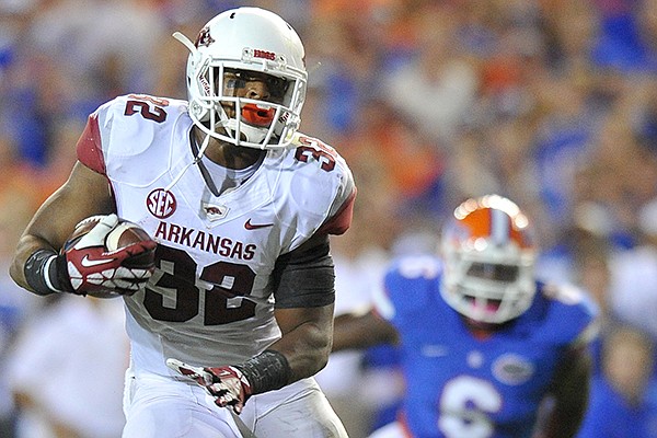 Arkansas running back Jonathan Williams runs around the Florida defense on his way to score a touchdown in the 1st quarter of Saturday night's game at Ben Hill Griffin Stadium in Gainesville, Florida.